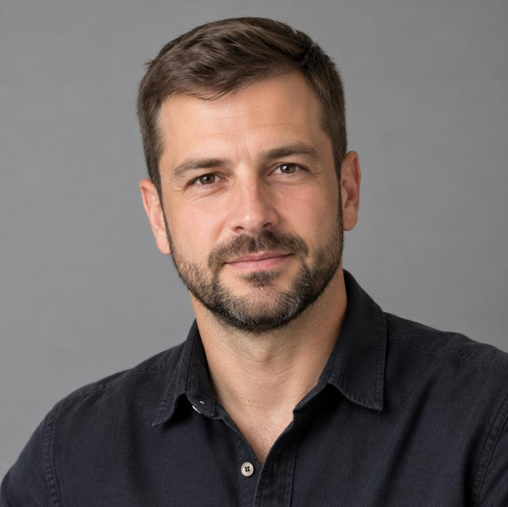 Portrait of a man with short hair in a casual shirt
